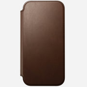 The Nomad Modern Leather Folio for iPhone 17 Pro Max in brown features full-grain leather with rounded edges and visible stitching, shown closed against a plain white background.