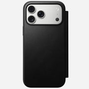 The Nomad Modern Leather Folio for iPhone 17 Pro Max in black is a MagSafe compatible leather flip case, shown from the back with three rear cameras against a light gray background.