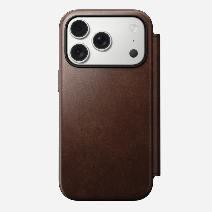 The Nomad Modern Leather Folio for iPhone 17 Pro in Rustic Brown Horween leather features a triple-camera cutout and MagSafe compatibility, shown from the back against a plain white background.