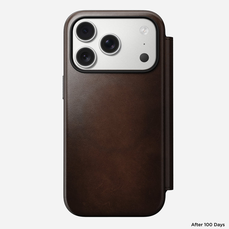 Nomad’s Modern Leather Folio for iPhone 17 Pro in Rustic Brown Horween leather is shown from the back, displaying three camera lenses. The case shows slight wear after 100 days of use, highlighting its natural aging.