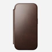 The Nomad Modern Leather Folio for iPhone 17 Pro in Rustic Brown features Horween leather, rounded edges, visible border stitching, a front cover shown closed on a light background, and is MagSafe compatible.