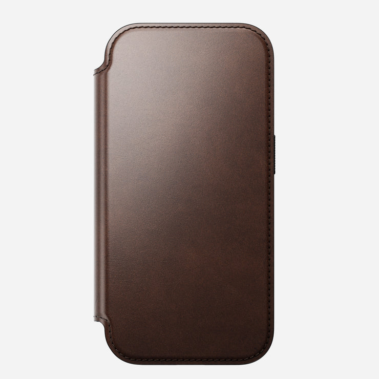 The Nomad Modern Leather Folio for iPhone 17 Pro in Rustic Brown features Horween leather, rounded edges, visible border stitching, a front cover shown closed on a light background, and is MagSafe compatible.
