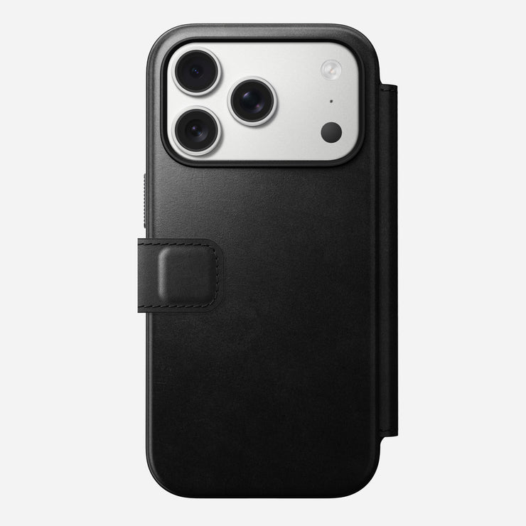The Nomad Modern Leather Folio for iPhone 17 Pro in black Horween leather-like material features a magnetic clasp and fits a smartphone with three rear cameras and a flash, shown on a plain white background.