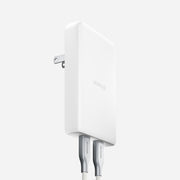 The Nomad AC Adapter - 100W | Slim | White is shown with two silver braided charging cables connected, featuring GaN technology, Dual USB-C PD, a foldable plug, and minimalist design against a plain light background.