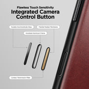 Close-up of the Nomad Modern Leather Case for iPhone 17 Pro Max (Burgundy, Horween) side button, highlighting durable aluminosilicate glass, flexible rubber membrane, anodized aluminum frame, and contact transmission plate for flawless touch sensitivity.