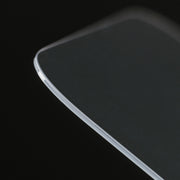A close-up of the Nomad Screen Protector for iPhone 17 Pro, a thin, clear rectangular glass sheet with smooth, rounded edges and a glossy surface, displayed against a black background.