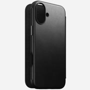 Angled front view of Modern Leather Folio for iPhone 16 Plus in Black by Nomad Leather. Shows full-grain leather with card slots, cash slot, and removable magnetic clasp. Provides 8ft drop protection and is compatible with MagSafe & wireless charging