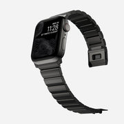 Side view of the Titanium Band for Apple Watch, showcasing the adjustable links and black finish