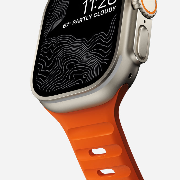 Close-up of the 45mm Sport Band in Ultra Orange, emphasizing the vibrant color and the custom aluminum closure pin