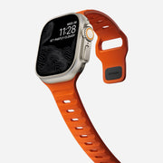 Side view of the 45mm Sport Band in Ultra Orange, focusing on its breathable design and custom aluminum closure pin.