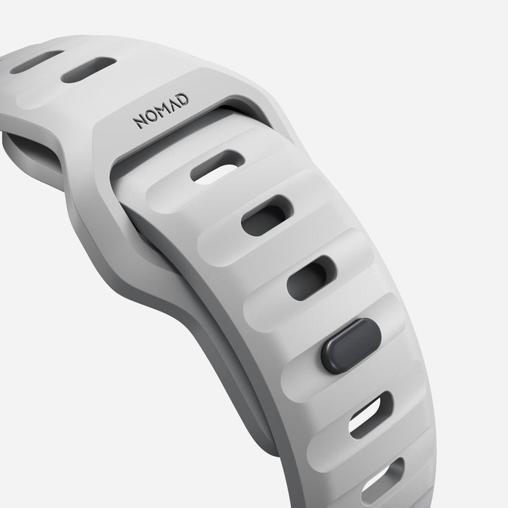 Close-up of the Lunar Gray Sport Band, showcasing its breathable material and custom aluminum closure pin 