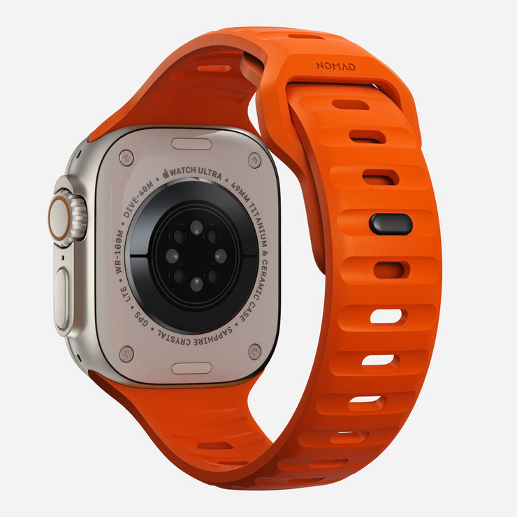 Back view of the Sport Band for Apple Watch in Ultra Orange, showing the interior ventilation channels and closure mechanism