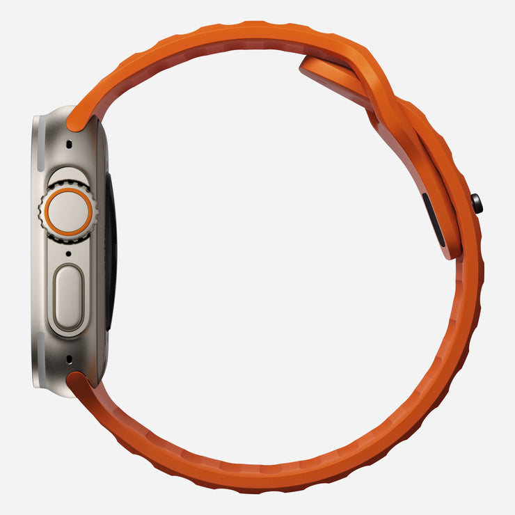 Side view of the Sport Band for Apple Watch in Ultra Orange, showing the profile and thickness of the FKM fluoroelastomer material