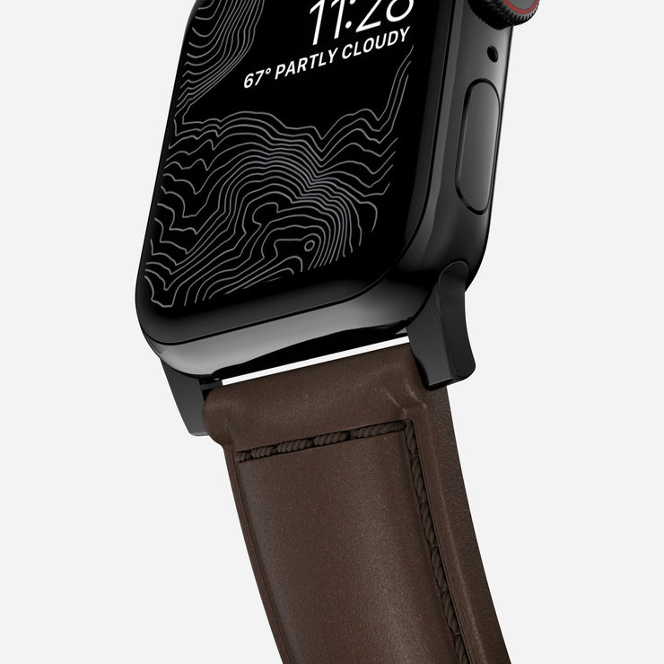 Close-up view of the Traditional Band for Apple Watch, highlighting the detailed stitching and texture of Rustic Brown Horween leather  